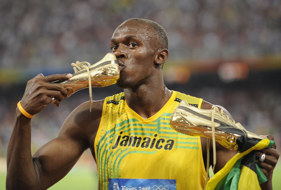 Jamaica's Usain Bolt kisses his shoe after winning the men's 100m final at the National stadium as part of the 2008 Beijing Olympic Games on August 16, 2008.