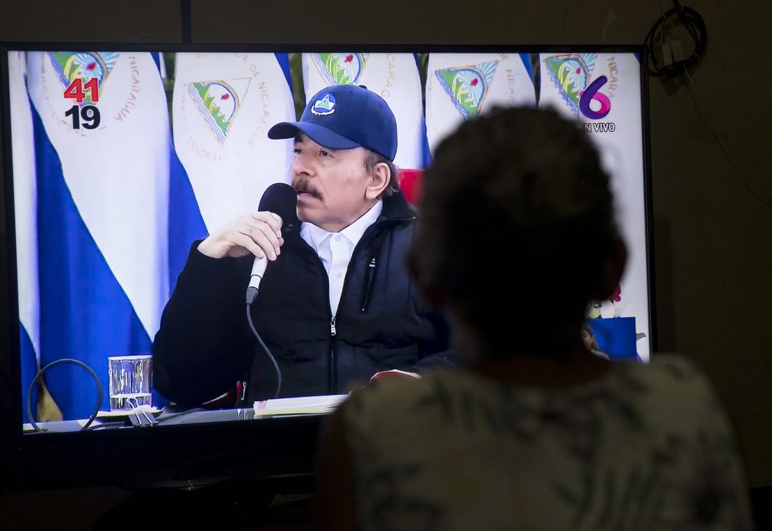 A woman views a television broadcast of Nicaraguan President Daniel Ortega's speech on Sunday.