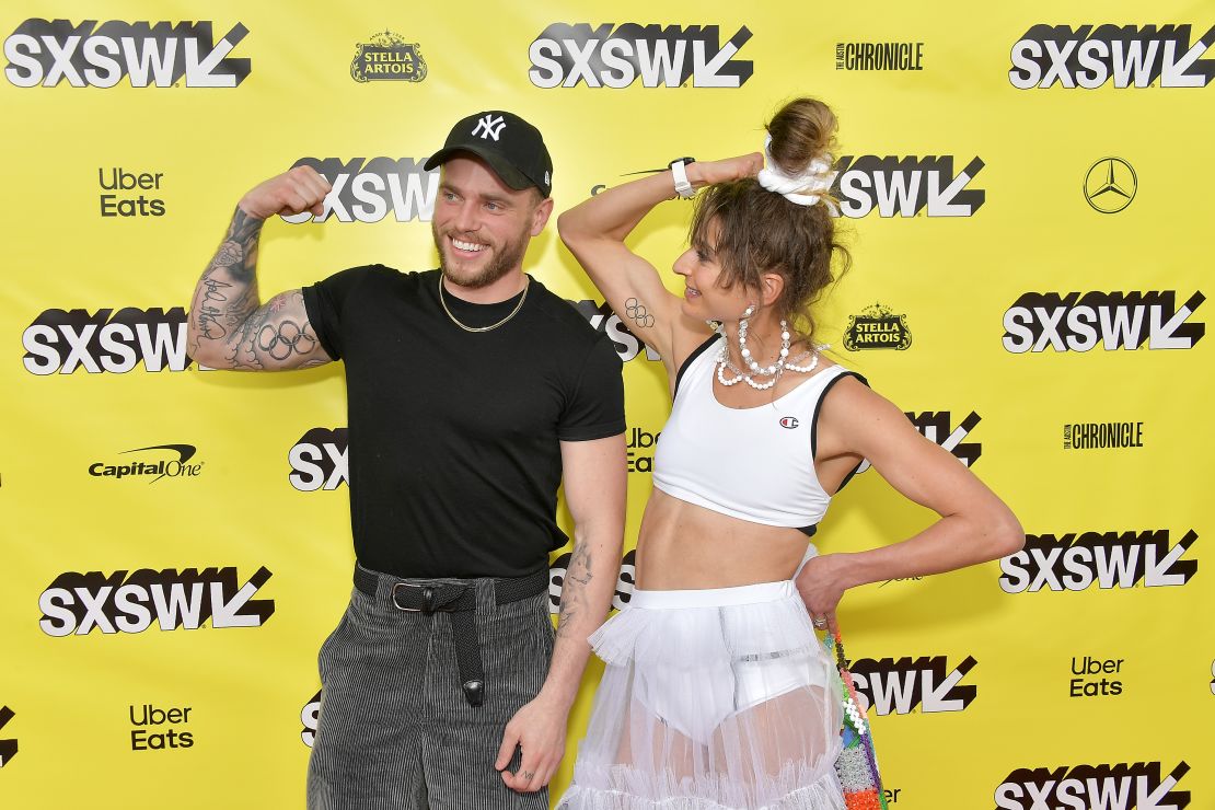 Alexi Pappas and Gus Kenworthy dispay their Olympic ring tattoos during the premiere of "Olympic Dreams" at the SXSW festival in Austin, Texas.