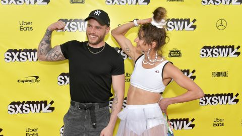 Alexi Pappas and Gus Kenworthy dispay their Olympic ring tattoos during the premiere of "Olympic Dreams" at the SXSW festival in Austin, Texas.