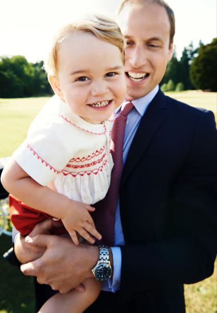 Prince George is held by his father a day before his second birthday in July 2015.