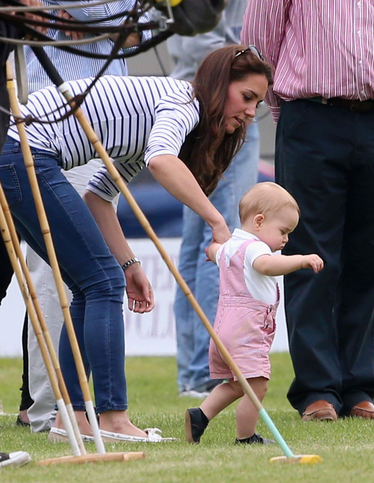 George takes his first steps in public as his mother holds his hand in June 2014.