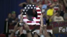 An attendee holds signs a sign of the letter "Q" before the start of a rally with U.S. President Donald Trump in Lewis Center, Ohio, U.S., on Saturday, Aug. 4, 2018.