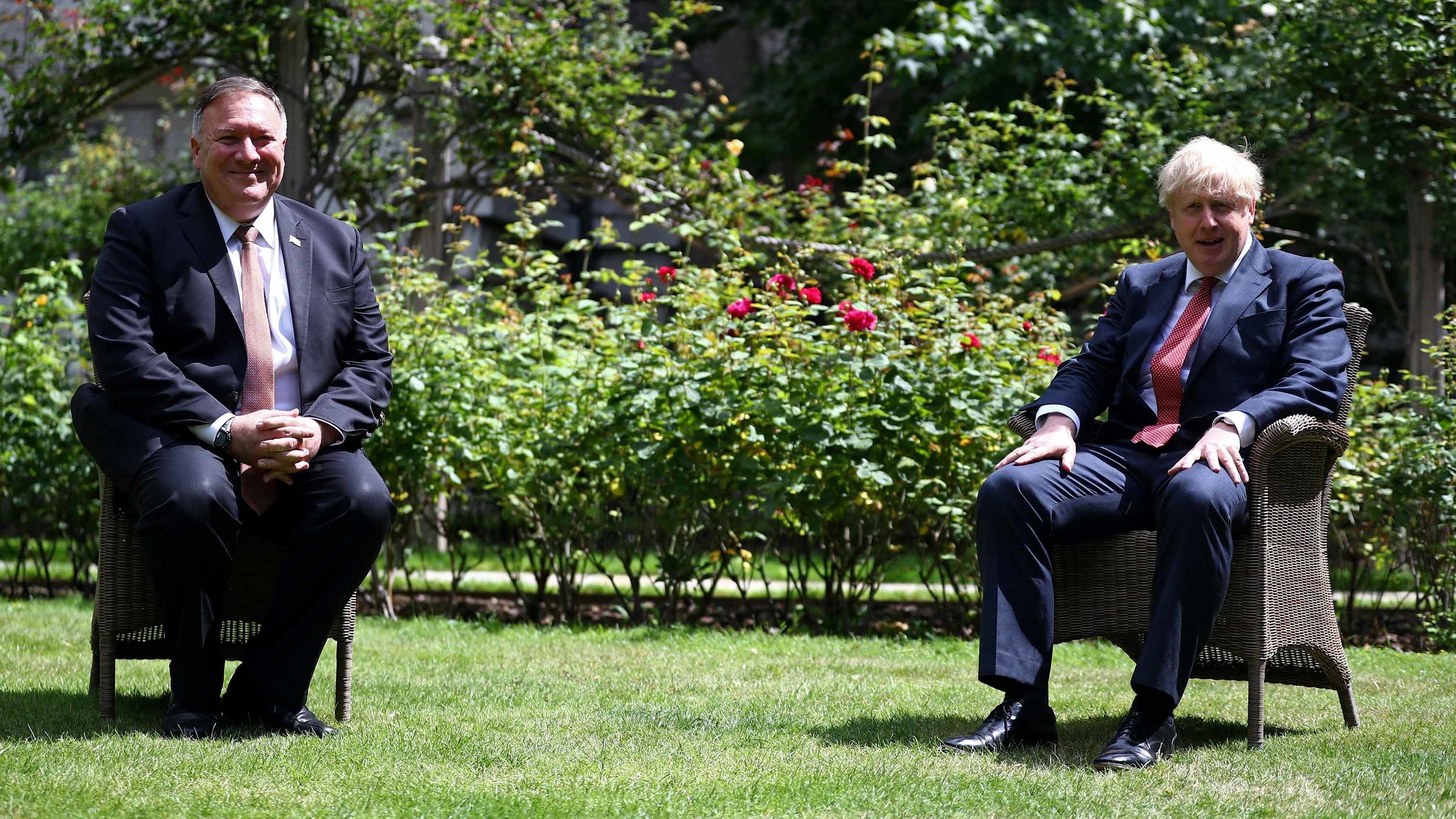 US Secretary of State Mike Pompeo sits across from Johnson in the garden of No. 10 Downing Street in July 2020.