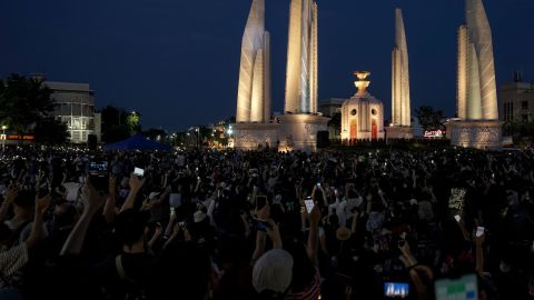 Protesters hold up their mobile phones during an anti-government demonstration at Democracy Monument in Bangkok on July 18.