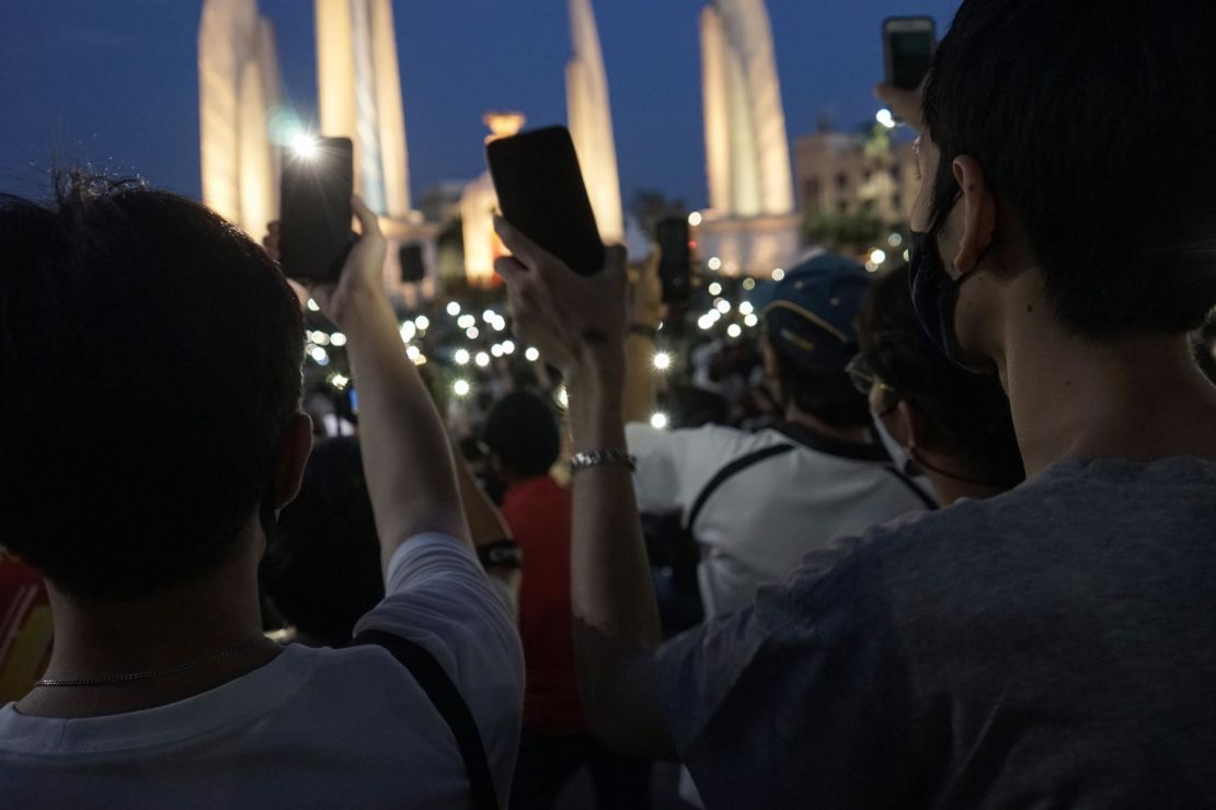 Protesters hold up their mobile phones during an anti-government demonstration at Democracy Monument in Bangkok on July 18.