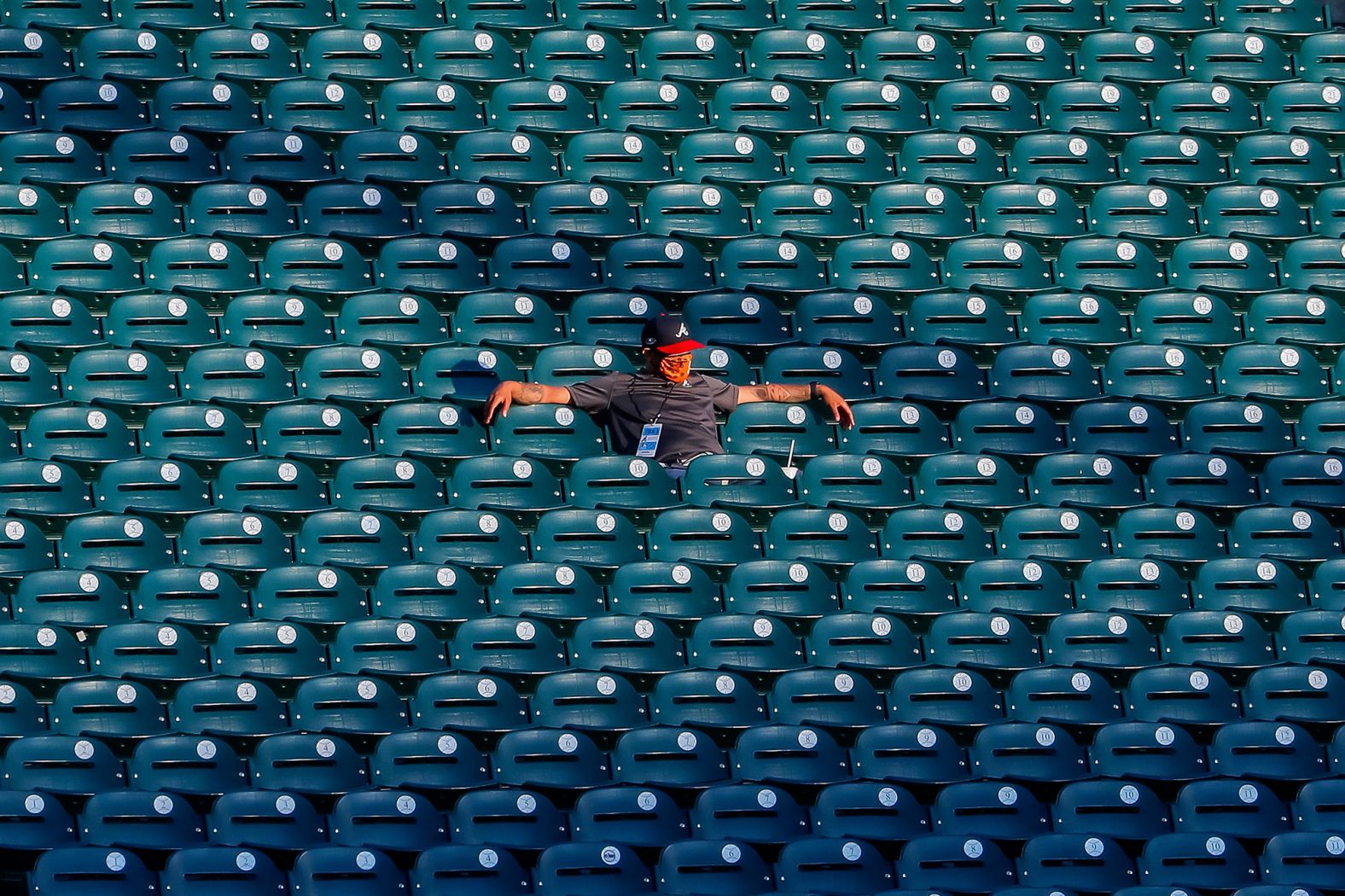 A stadium worker watches an Atlanta Braves scrimmage on July 13.
