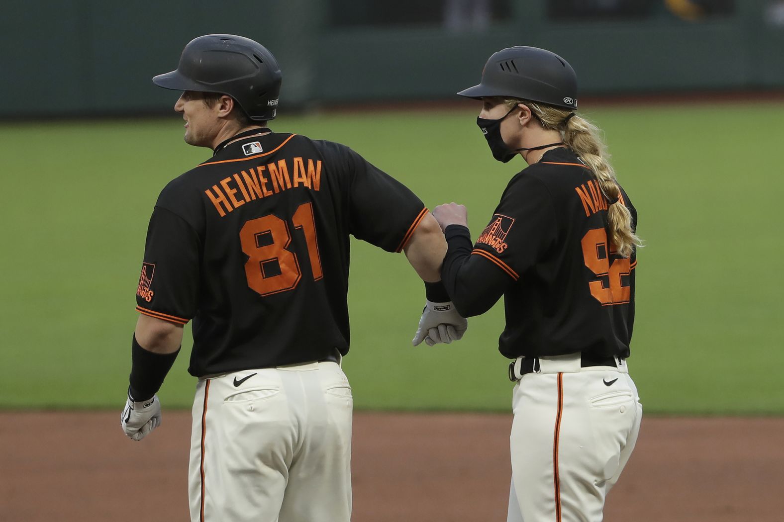 San Francisco's Tyler Heineman bumps forearms with first-base coach Alyssa Nakken during a preseason game on July 21. Nakken was making history as <a href="index.php?page=&url=https%3A%2F%2Fwww.cnn.com%2F2020%2F07%2F21%2Fus%2Fwoman-coach-san-francisco-giants-spt-trnd%2Findex.html" target="_blank">the first woman to ever coach in Major League Baseball.</a>