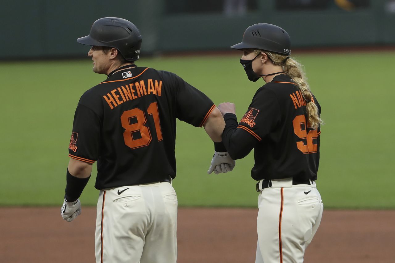 San Francisco's Tyler Heineman bumps forearms with first-base coach Alyssa Nakken during a preseason game on July 21. Nakken was making history as <a href="https://www.cnn.com/2020/07/21/us/woman-coach-san-francisco-giants-spt-trnd/index.html" target="_blank">the first woman to ever coach in Major League Baseball.</a>