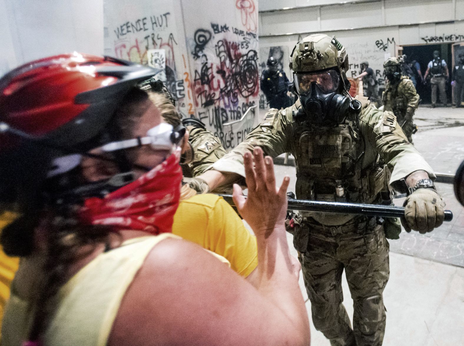 A federal officer pushes back demonstrators at the US courthouse on July 21.