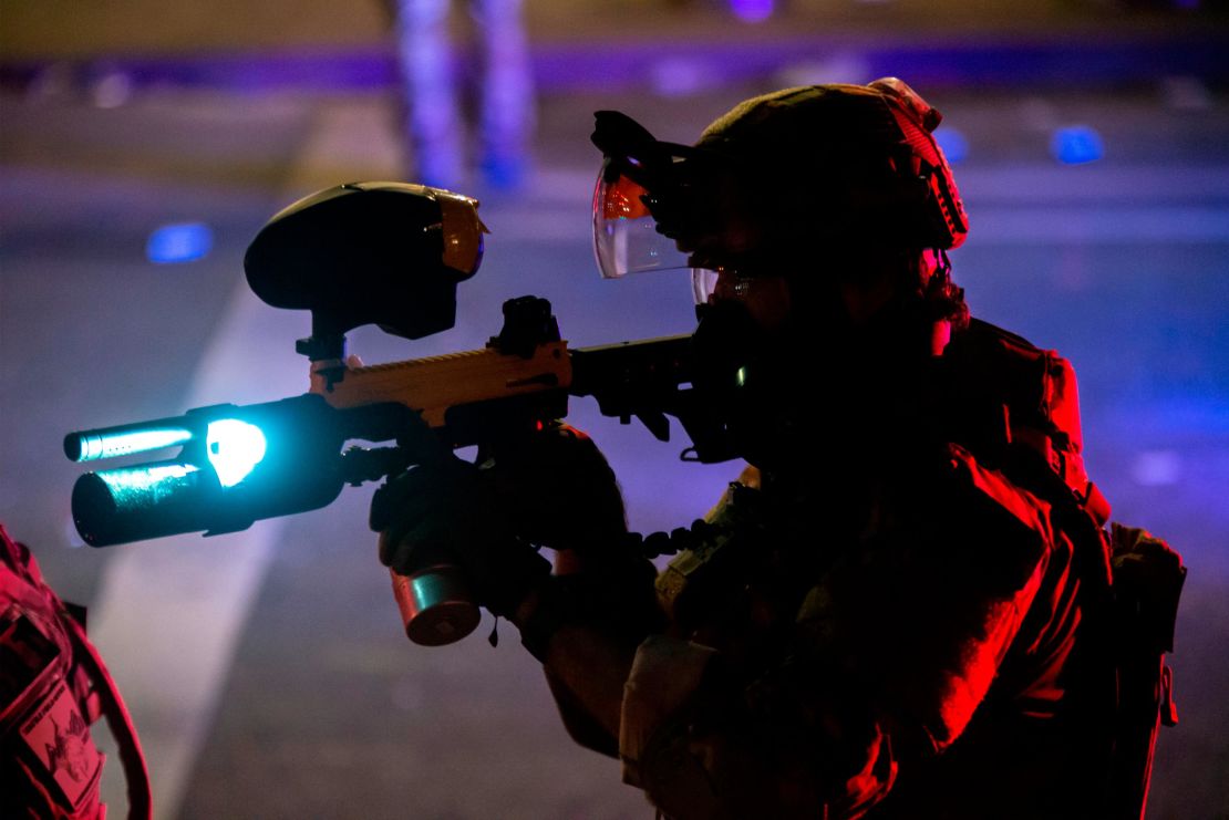 A federal office points a pepperball gun at a protester while dispersing a crowd in front of the Mark O. Hatfield U.S. Courthouse on July 22, 2020 in Portland, Oregon.