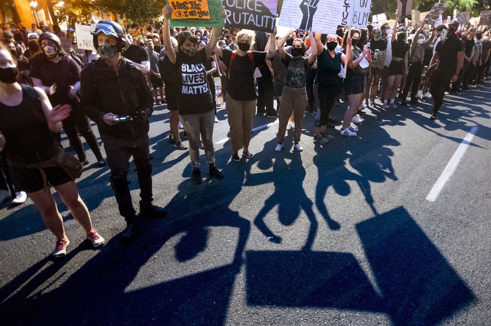 Protesters hold signs on July 21.