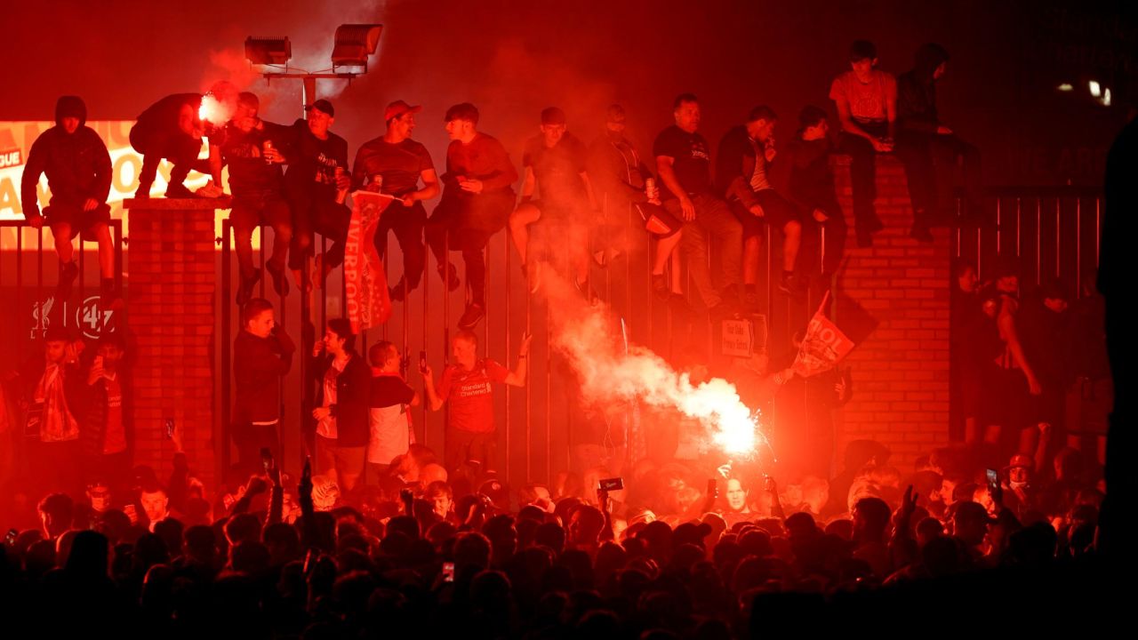 Liverpool fans celebrate outside Anfield stadium during the Premier League trophy presentation.