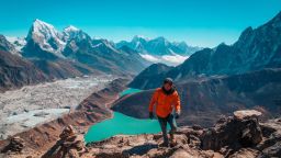 Pete Rojwongsuriya, a travel blogger based in Thailand, treks up Gokyo Ri in Nepal, overlooking Mount Everest on the horizon. 