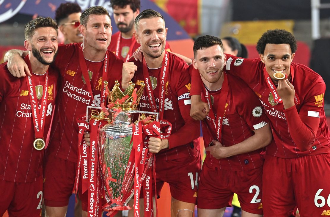 Liverpool players pose with the Premier League trophy during the presentation.