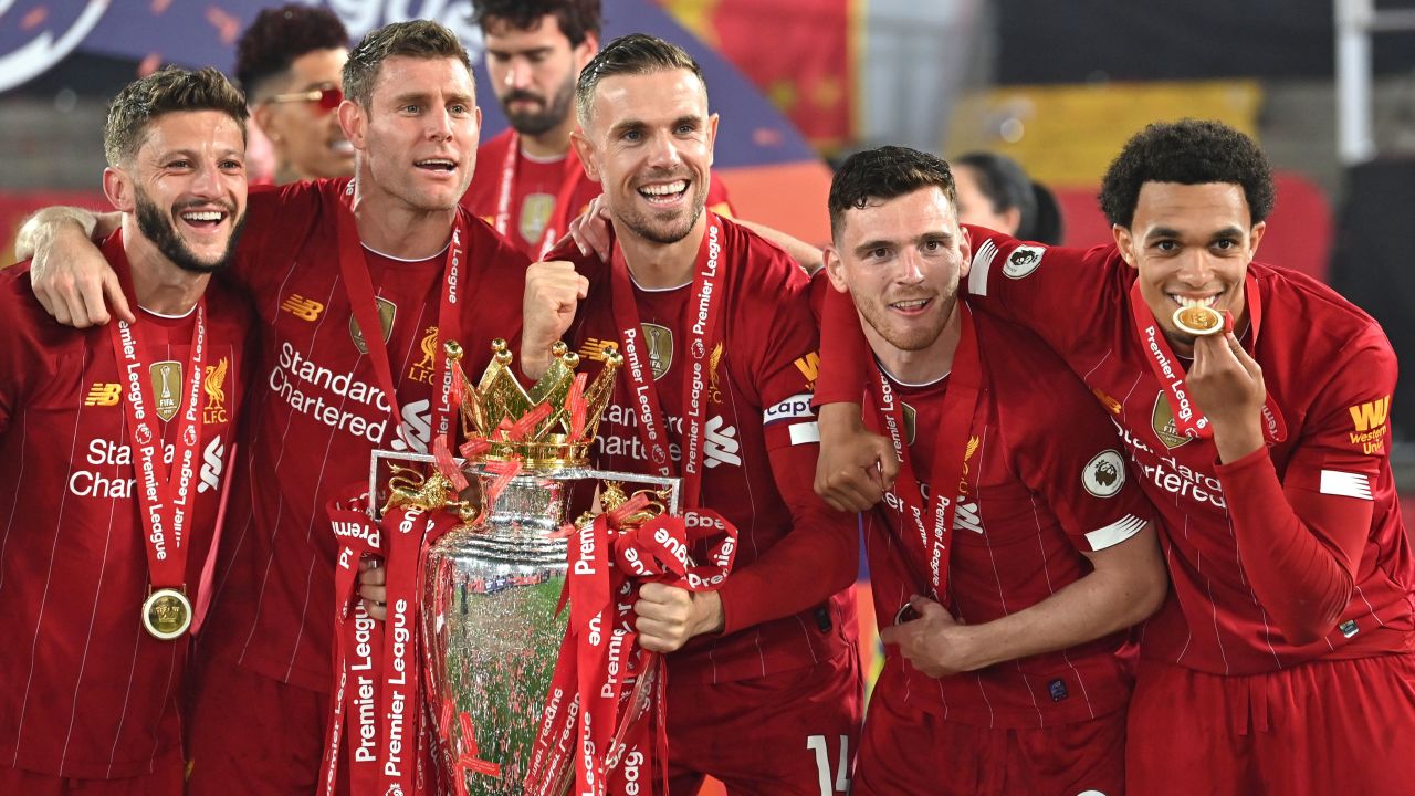 Liverpool players celebrate with the Premier League trophy. 