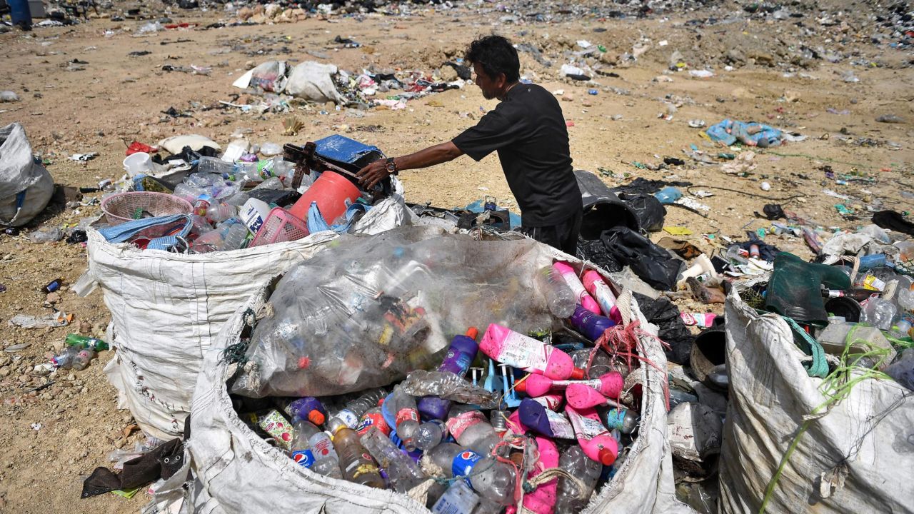 A garbage collector gathering recyclable plastic at the Ban Tarn landfill site in the Thai province of Chiang Mai.