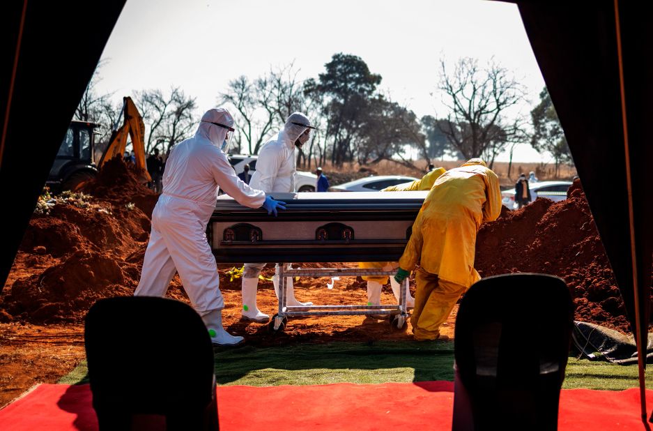 Undertakers push the casket of a coronavirus victim during a funeral in Soweto, South Africa, on July 21.