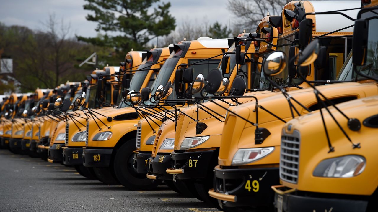 About 100 school buses are parked at the Arlington County Bus Depot,  in response to the novel coronavirus, COVID-19 outbreak on March 31, 2020 in Arlington, Virginia. - Forty-seven states and the District of Columbia have decided to close schools in response to the coronavirus pandemic, affecting nearly 55 million students and seven US states have closed school for the remainder of the year, as the coronavirus outbreak continues to spread across the country. (Photo by Olivier DOULIERY / AFP) (Photo by OLIVIER DOULIERY/AFP via Getty Images)