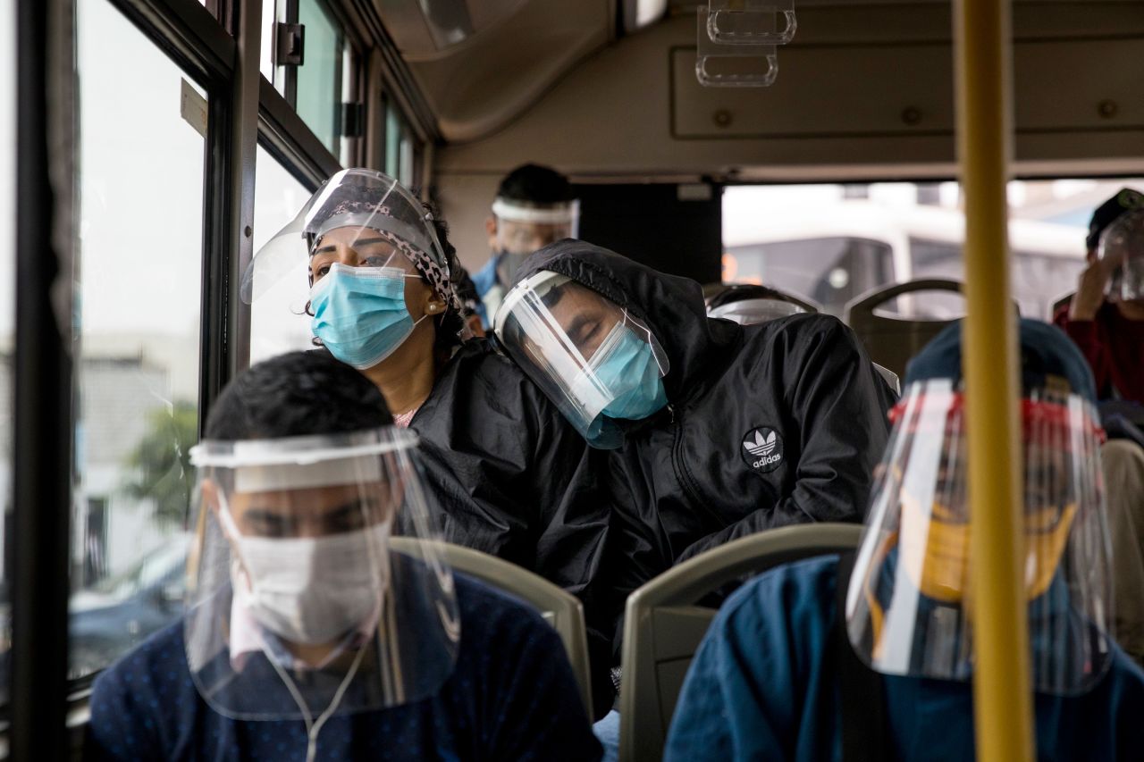 Commuters wear face masks and face shields while traveling on a public bus in Lima, Peru, on July 22. Peru has mandated masks and shields on public transportation.