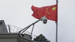 The flag of China flies behind a security camera over the Chinese Consulate in San Francisco, Thursday, July 23, 2020. The Chinese consulate in San Francisco is harboring a Chinese researcher who the FBI says lied about her military background. (AP Photo/Jeff Chiu)