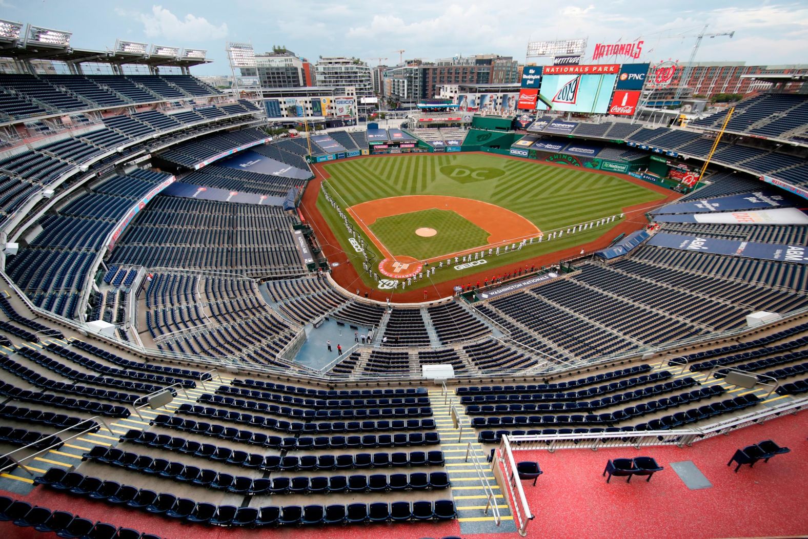 The Washington Nationals and the New York Yankees line up on the field prior to Major League Baseball's season-opening game on Thursday, July 23.