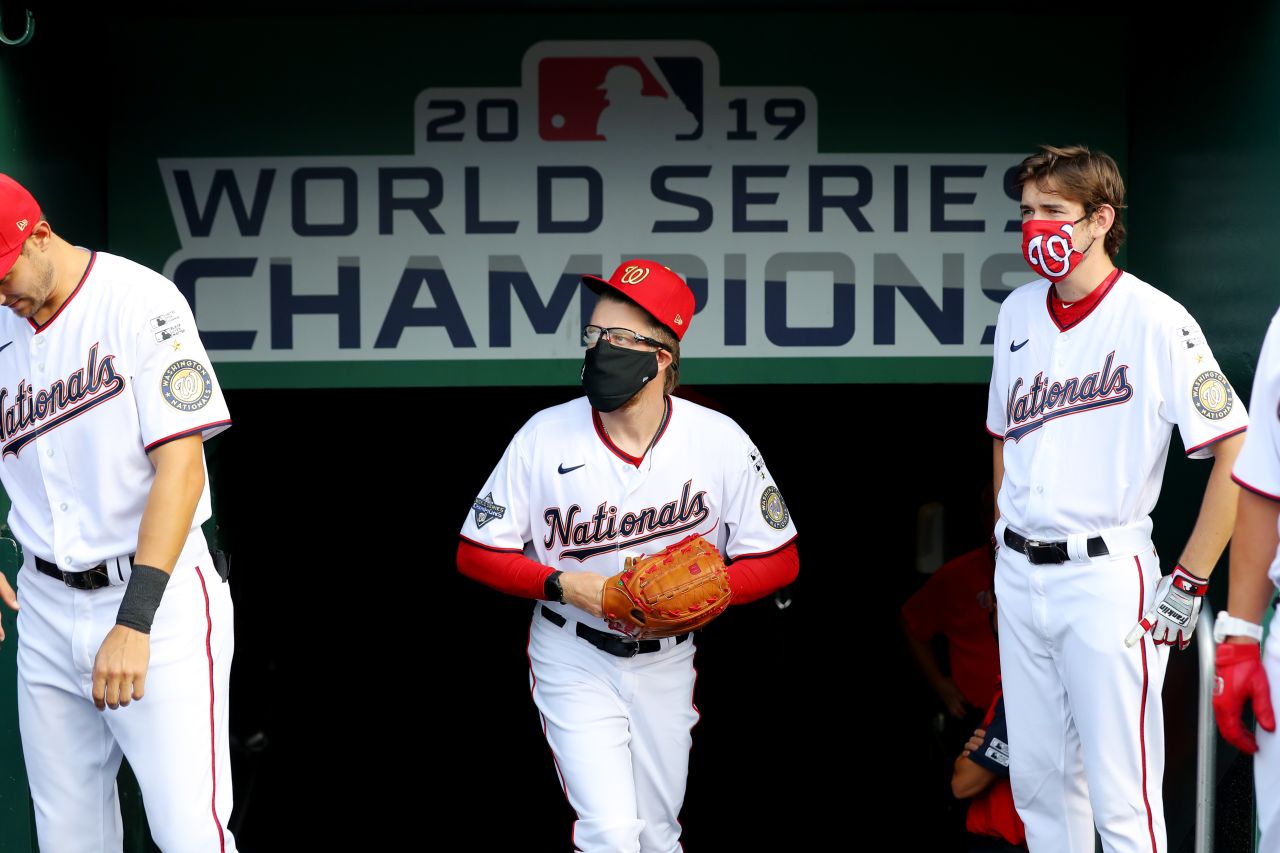 Washington reliever Sean Doolittle, center, wears a face mask in the dugout before Thursday's game.