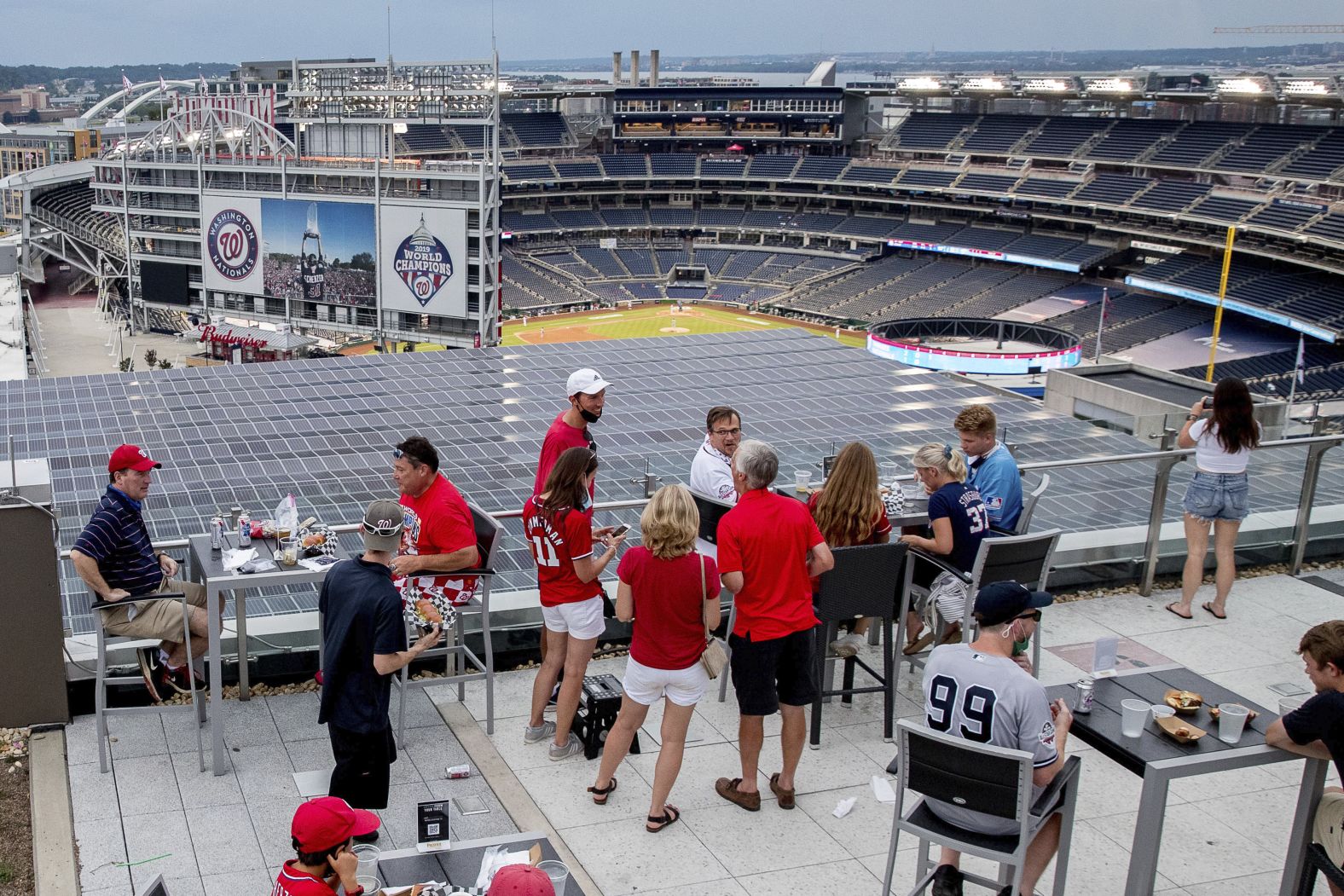 People watch the opener from a rooftop bar overlooking Nationals Park.