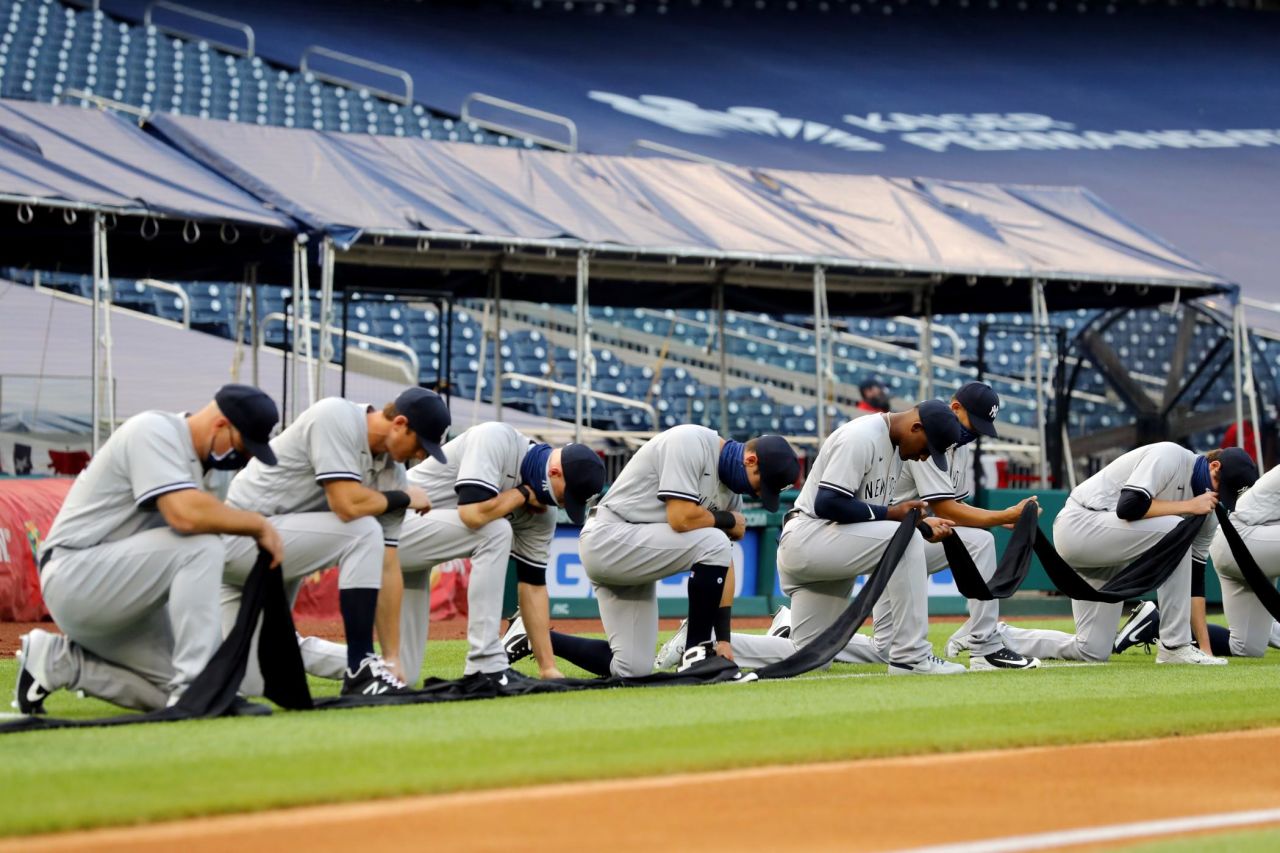 The Yankees kneel for a moment of silence before standing for the National Anthem on Thursday. The Nationals also took a knee to show their support for the Black Lives Matter movement. The initials BLM were on the pitcher's mound for the game.