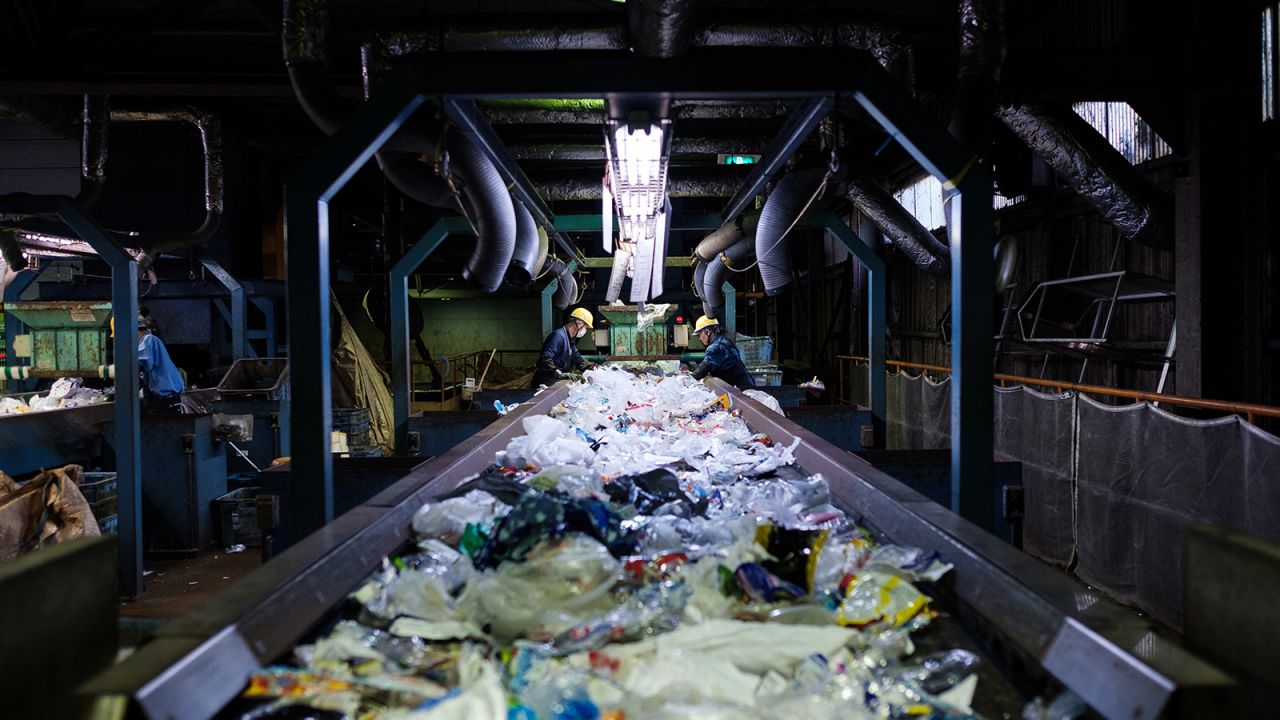 Workers sort disposable plastic waste on a conveyor at Ichikawa Kankyo Engineering recycle center. Tokyo's Katsushika city office brings some 10 tons of plastic recyclable resources to the recycling facility daily.