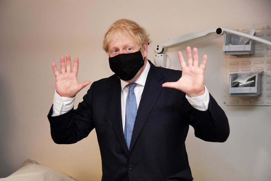 Boris Johnson wears a face mask as he visits a medical center in London on Friday.