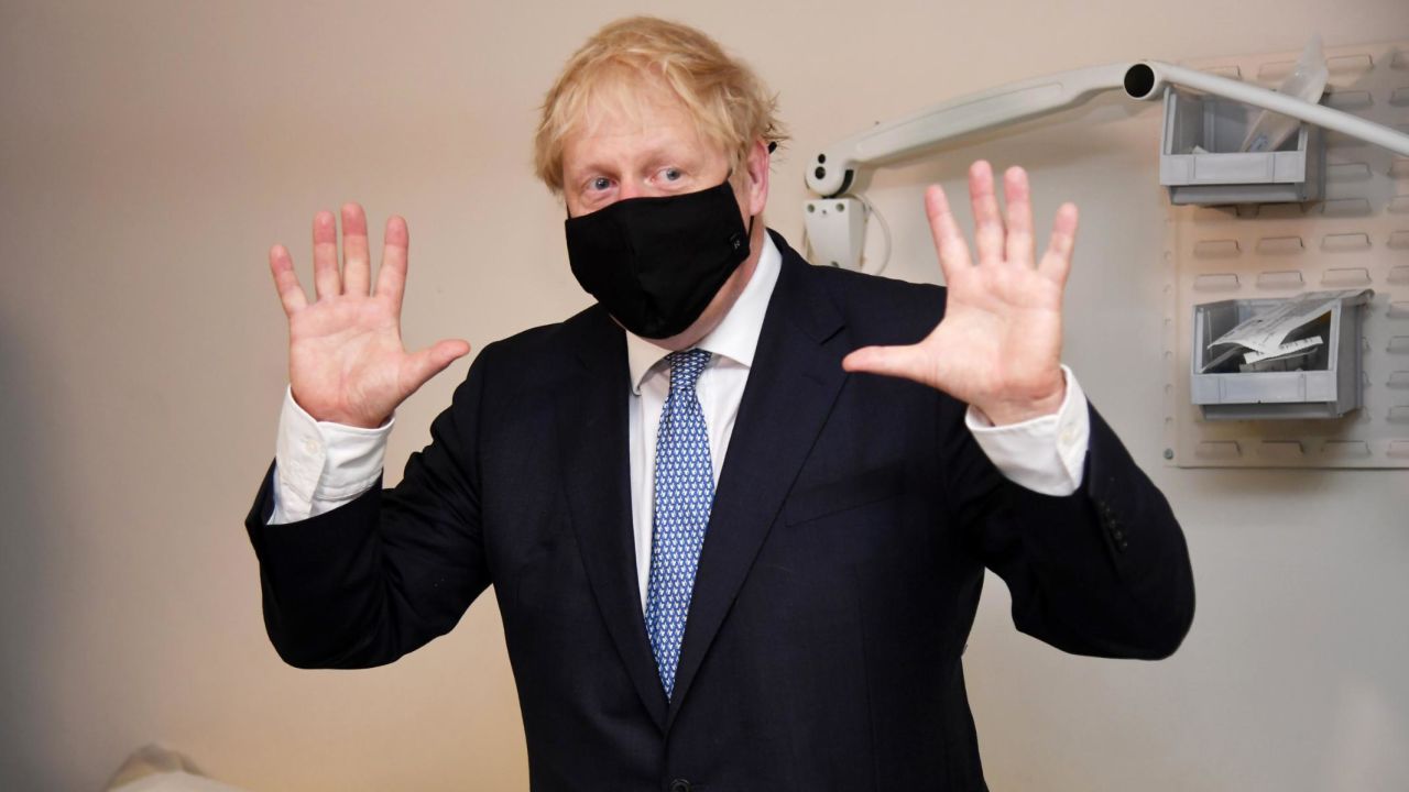 Boris Johnson wears a face mask as he visits a medical center in London on Friday.