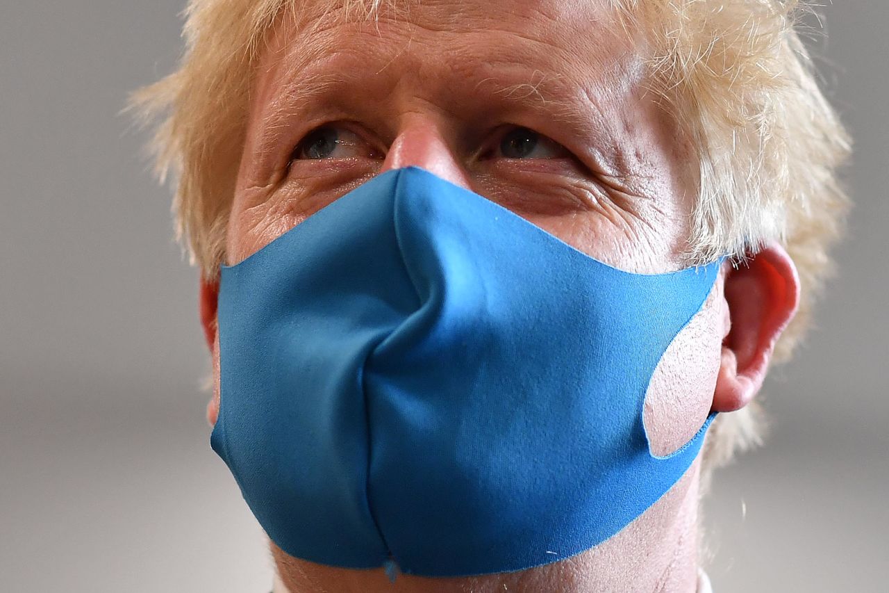 Johnson wears a face mask as he visits the headquarters of the London Ambulance Service NHS Trust in July 2020.