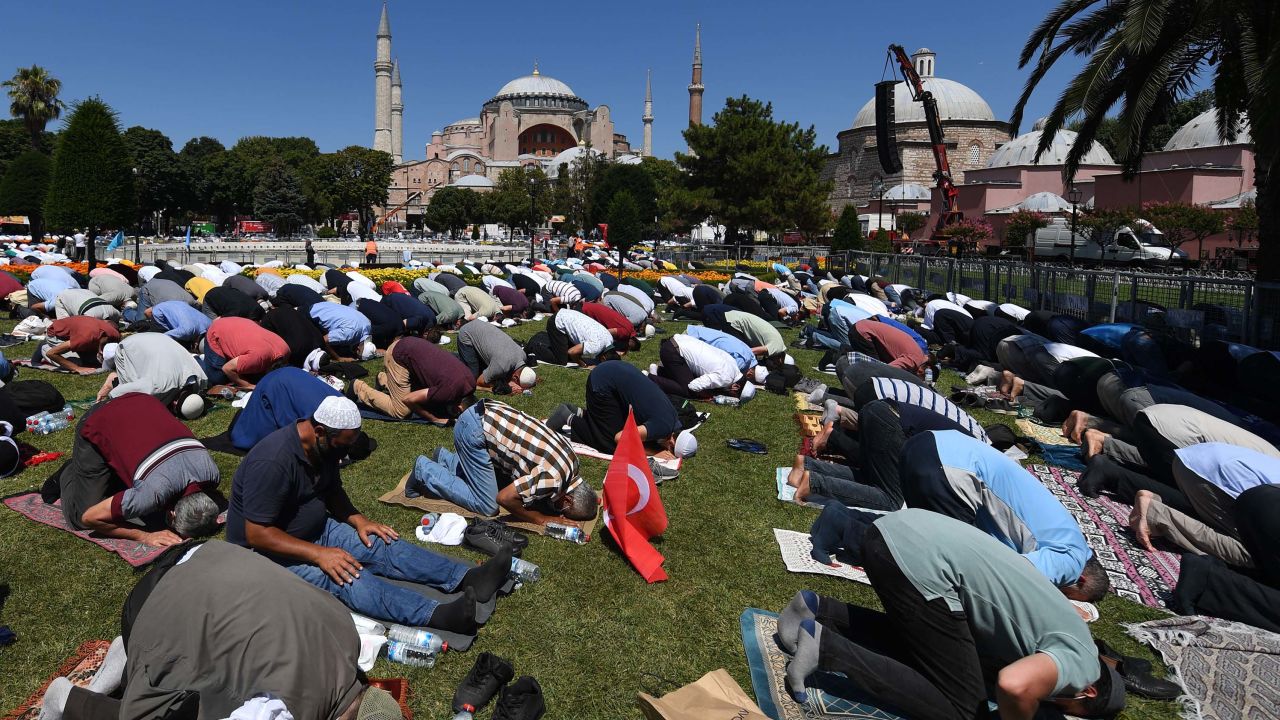 Men take part in Friday prayers outside Hagia Sophia in Istanbul on July 24, 2020.