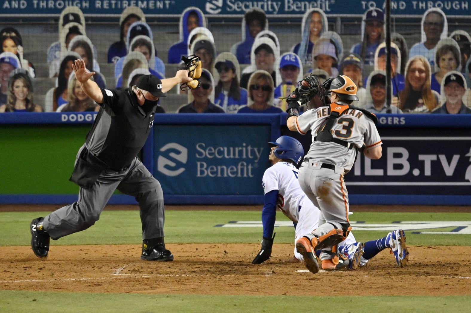 Umpire Bill Miller calls Mookie Betts safe at home plate, scoring a run for the Dodgers on Thursday.