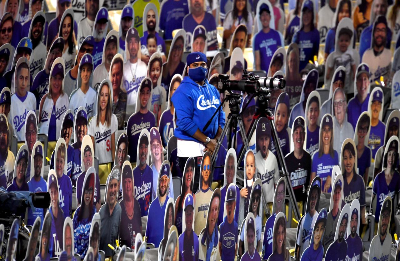 A camera operator stands in the middle of fan cutouts in Los Angeles.