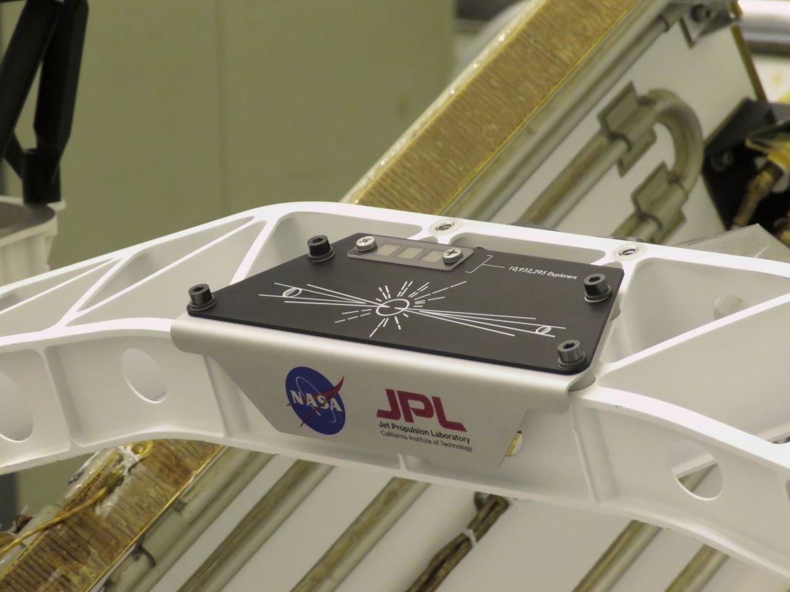 This placard holds the names submitted during the "Send Your Name to Mars" campaign. Three fingernail-size chips contain the names of 10,932,295 people who participated.