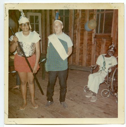 Typical camp fun: These three campers are wearing face paint and outlandish homemade costumes, including pointy party hats made out of aluminum foil and construction paper.