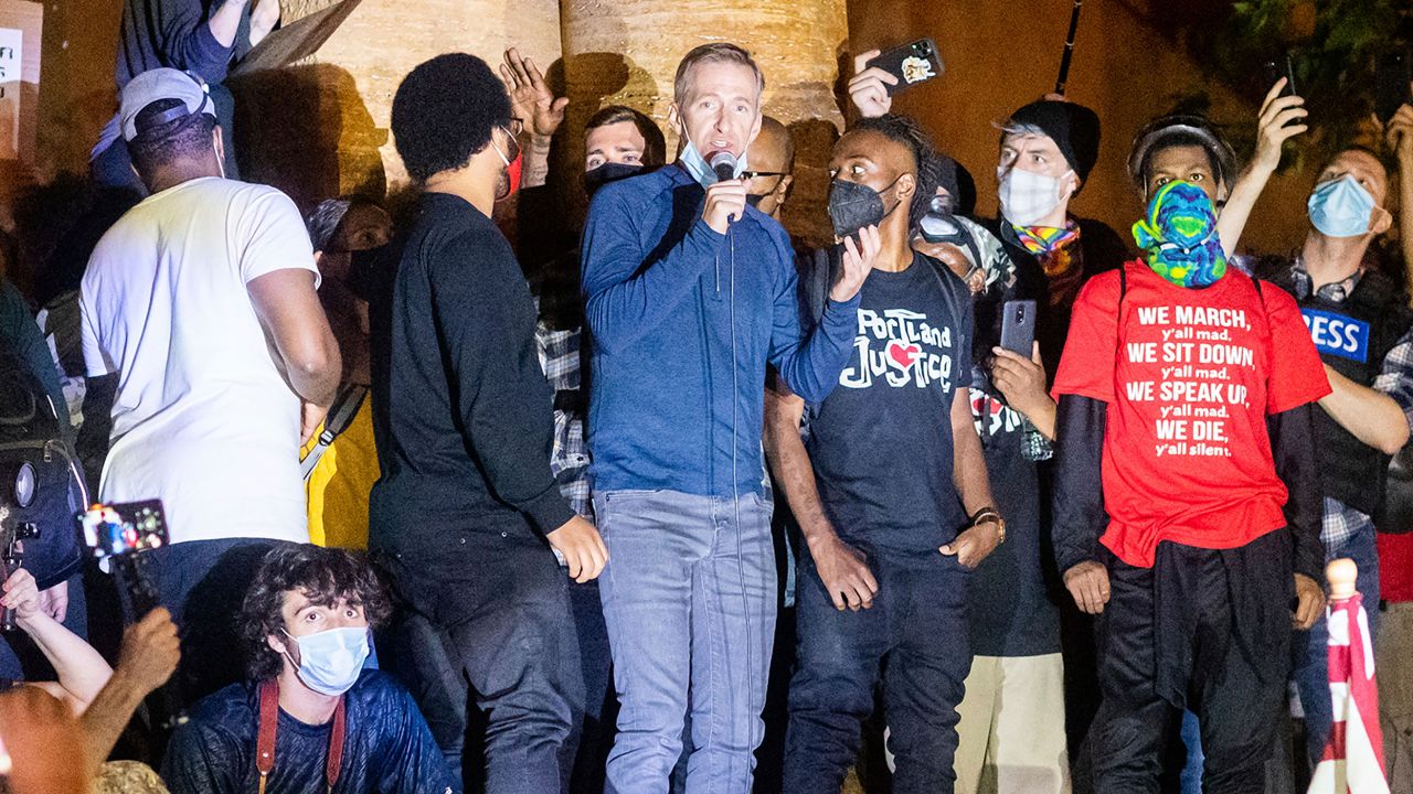 Portland Mayor Ted Wheeler speaks to Black Lives Matter protesters on Wednesday, July 22, 2020, in Portland, Ore. Late Wednesday Wheeler joined protesters at the front of the crowd and was hit with chemical irritants several times by federal officers dispersing demonstrators. (AP Photo/Noah Berger)