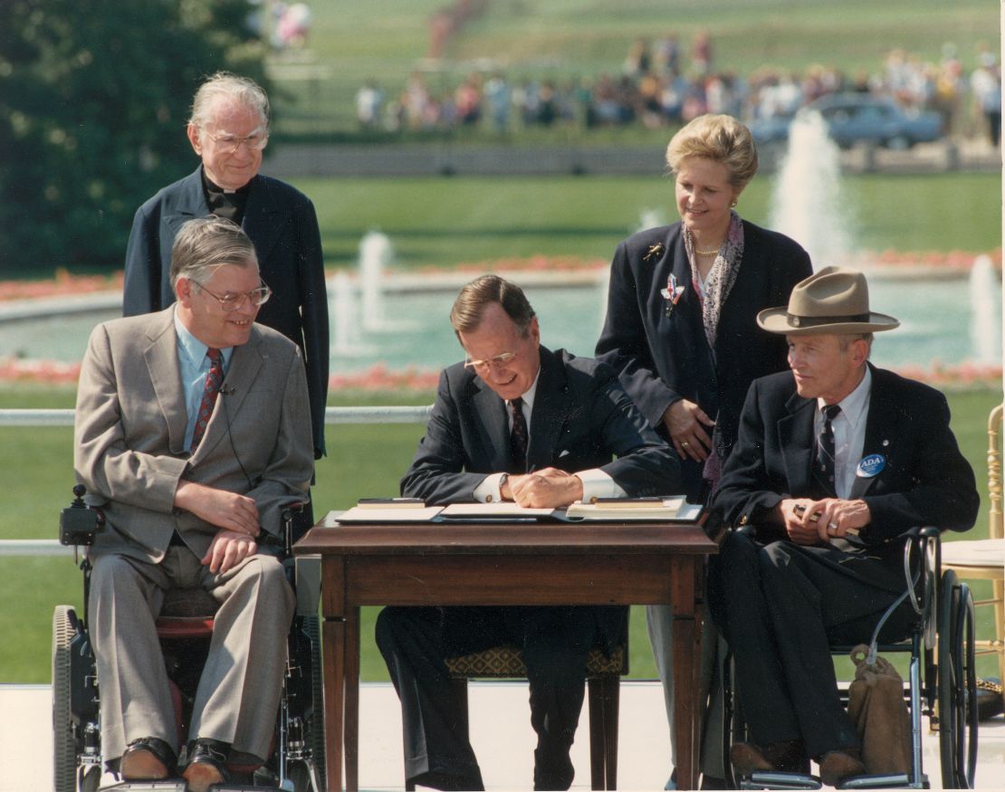 George Bush signs the Americans with Disabilities Act of 1990.