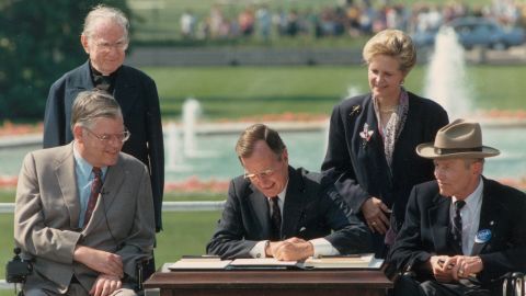 George Bush signs the Americans with Disabilities Act of 1990.