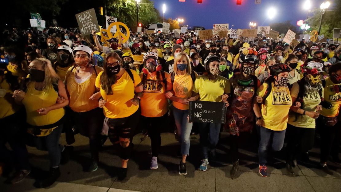 Demonstrators march during a Black Lives Matter protest Friday, July 24, 2020, in Portland, Oregon.