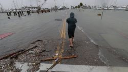 A man takes photos of a road beginning to flood as Hurricane Hanna makes landfall, Saturday, July 25, 2020, in Corpus Christi, Texas.   The National Hurricane Center said Saturday morning that Hanna's maximum sustained winds had increased and that it was expected to make landfall Saturday afternoon or early evening. (AP Photo/Eric Gay)