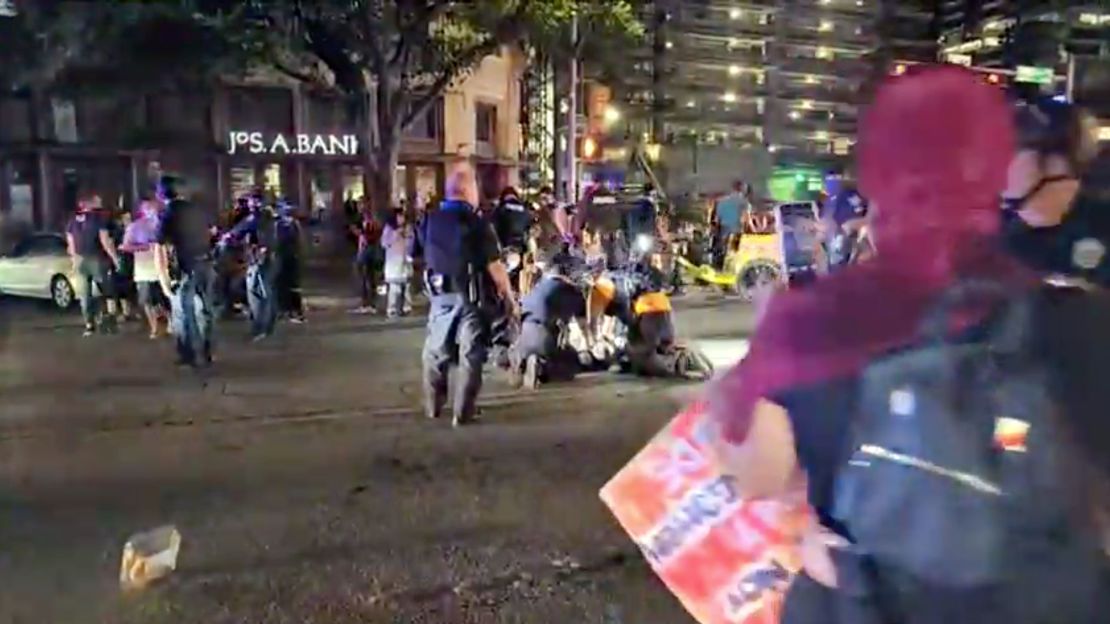 Police and protesters gather around a demonstrator who got shot after several shots were fired during a Black Lives Matter protest in downtown Austin, Texas, on July 25, 2020, in this screen grab obtained from a social media video.