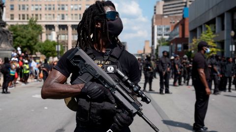 Members of the "Not F**ing Around Coalition" (NFAC), an all black militia, march during a rally to protest the killing of Breonna Taylor, in Louisville, Kentucky on  July 25, 2020. 