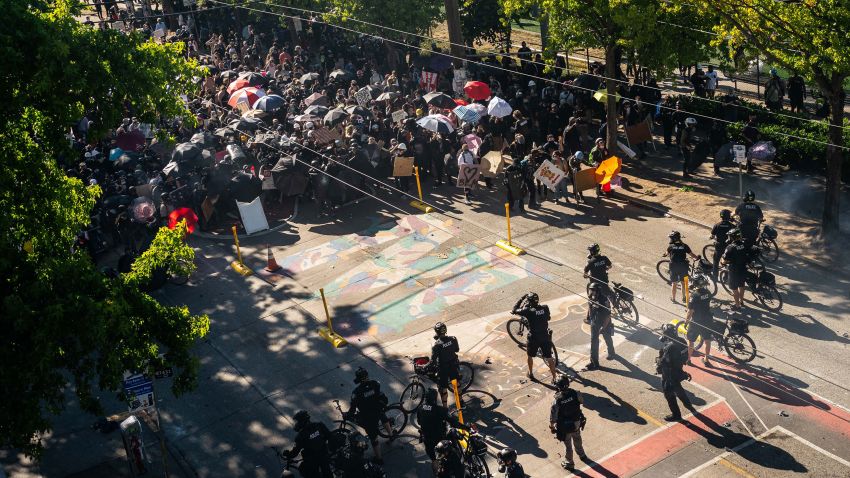 SEATTLE, WA - JULY 25: Police push demonstrators back atop a Black Lives Matter street mural in the area formerly known as CHOP during protests in Seattle on July 25, 2020 in Seattle, Washington. Police and demonstrators clash as protests continue in the city following reports that federal agents may have been sent to the city. (Photo by David Ryder/Getty Images)