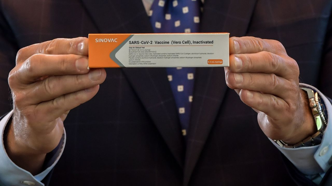 Sao Paulo State Governor Joao Doria displays a box of the COVID-19 vaccine produced by the Chinese company Sinovac Biotech at the Hospital das Clinicas (HC) in Sao Paulo State on July 21, 2020.