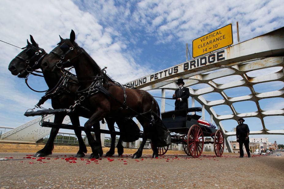 Lewis' casket is pulled by a horse-drawn carriage over the Edmund Pettus Bridge in Selma, Alabama, on Sunday.