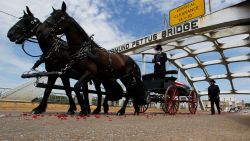 The casket of Rep. John Lewis moves over the Edmund Pettus Bridge by horse drawn carriage during a memorial service for Lewis, Sunday, July 26, 2020, in Selma, Ala. Lewis, who carried the struggle against racial discrimination from Southern battlegrounds of the 1960s to the halls of Congress, died Friday, July 17, 2020. (AP Photo/John Bazemore)