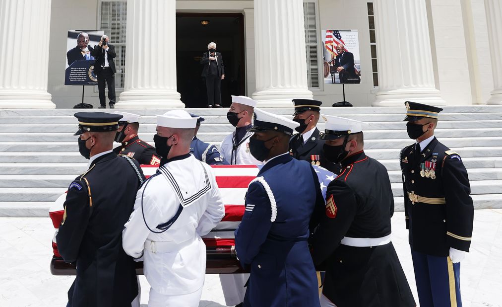 Alabama Gov. Kay Ivey stands in the doorway as military pallbearers carry Lewis' casket on Sunday.